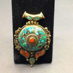 Tibetan brass with turquoise and coral turquoise inlay. Nice weight and size!